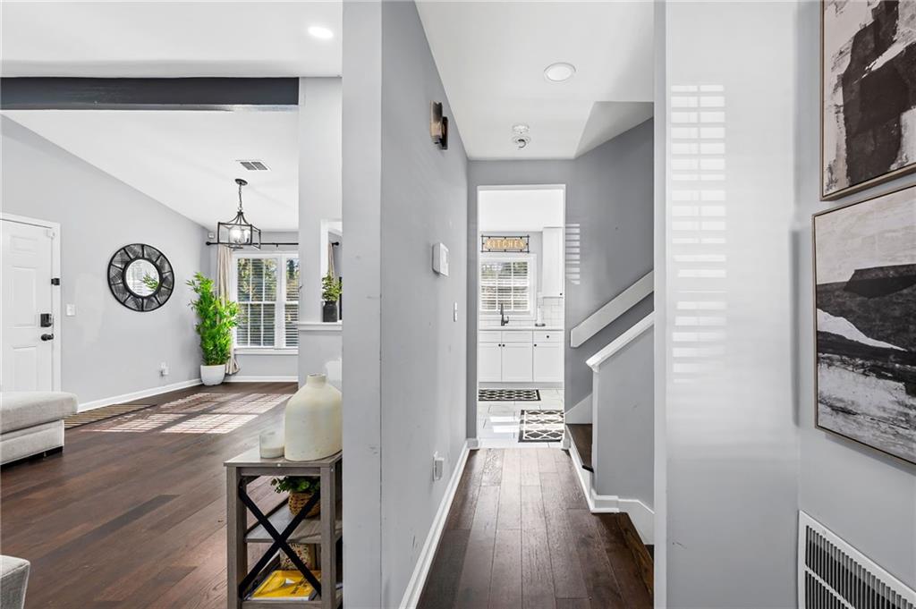 2468 Leslie Brook Drive Decatur, GA 30035 - Photo 6 of 39 a view of a hallway to a livingroom with furniture wooden floor and windows