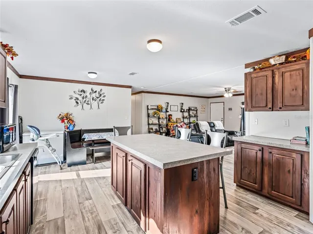 a bedroom with a bed wooden floor and window