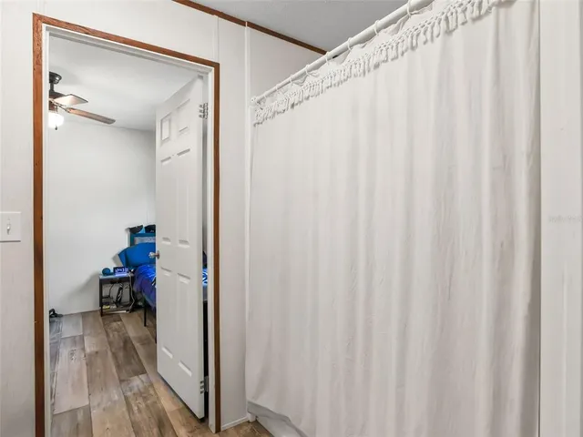 an aerial view of residential houses with outdoor space and trees