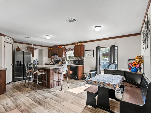 a view of a dining room with furniture and window