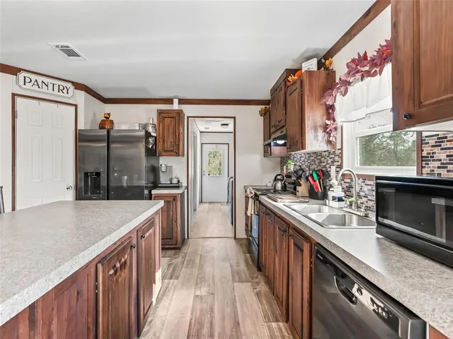 a kitchen with stainless steel appliances granite countertop a stove and a refrigerator