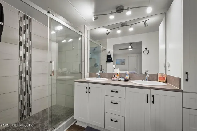a bathroom with a shower sink and mirror