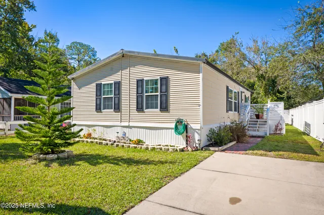 an aerial view of residential house with swimming pool and green space