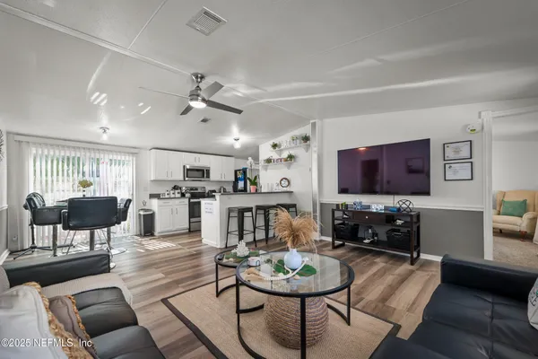 a kitchen with lots of counter space and view of living room
