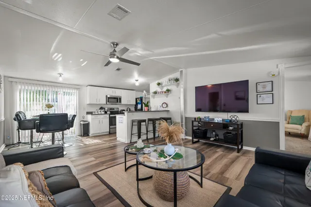 a kitchen with lots of counter space and view of living room