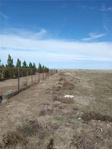 a view of an outdoor space with wooden floor and fence