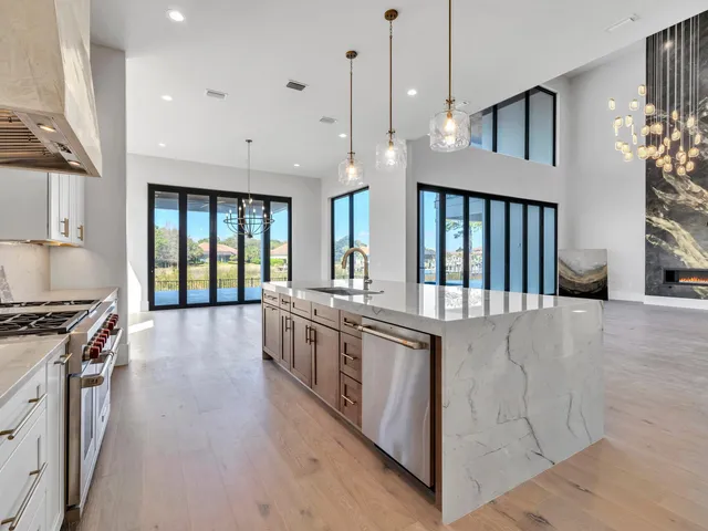 a kitchen with stainless steel appliances granite countertop a stove a sink and a microwave