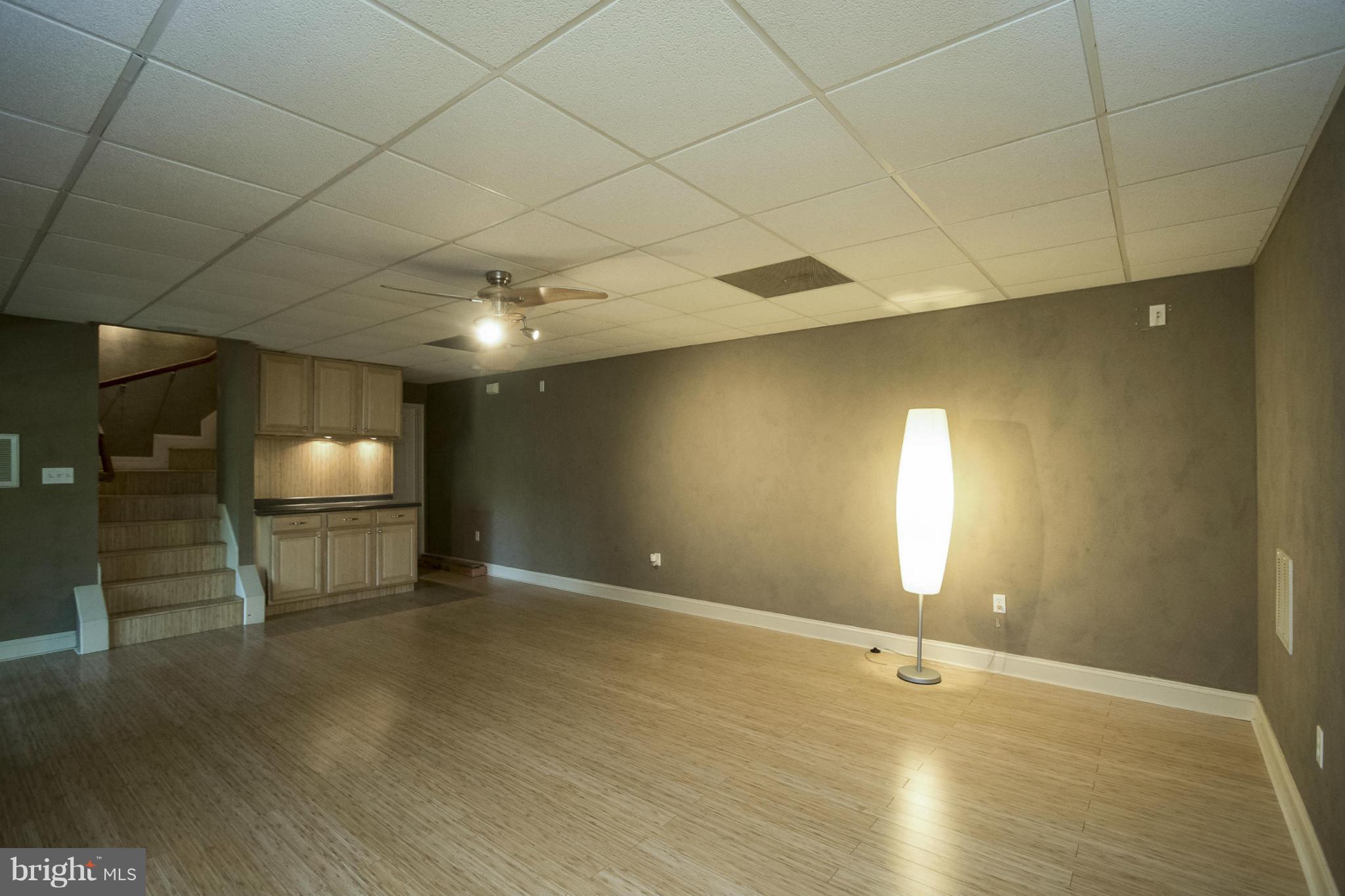 610 Running Fox Road Lusby, MD 20657 - Photo 14 of 30 a view of an empty room with window and chandelier fan