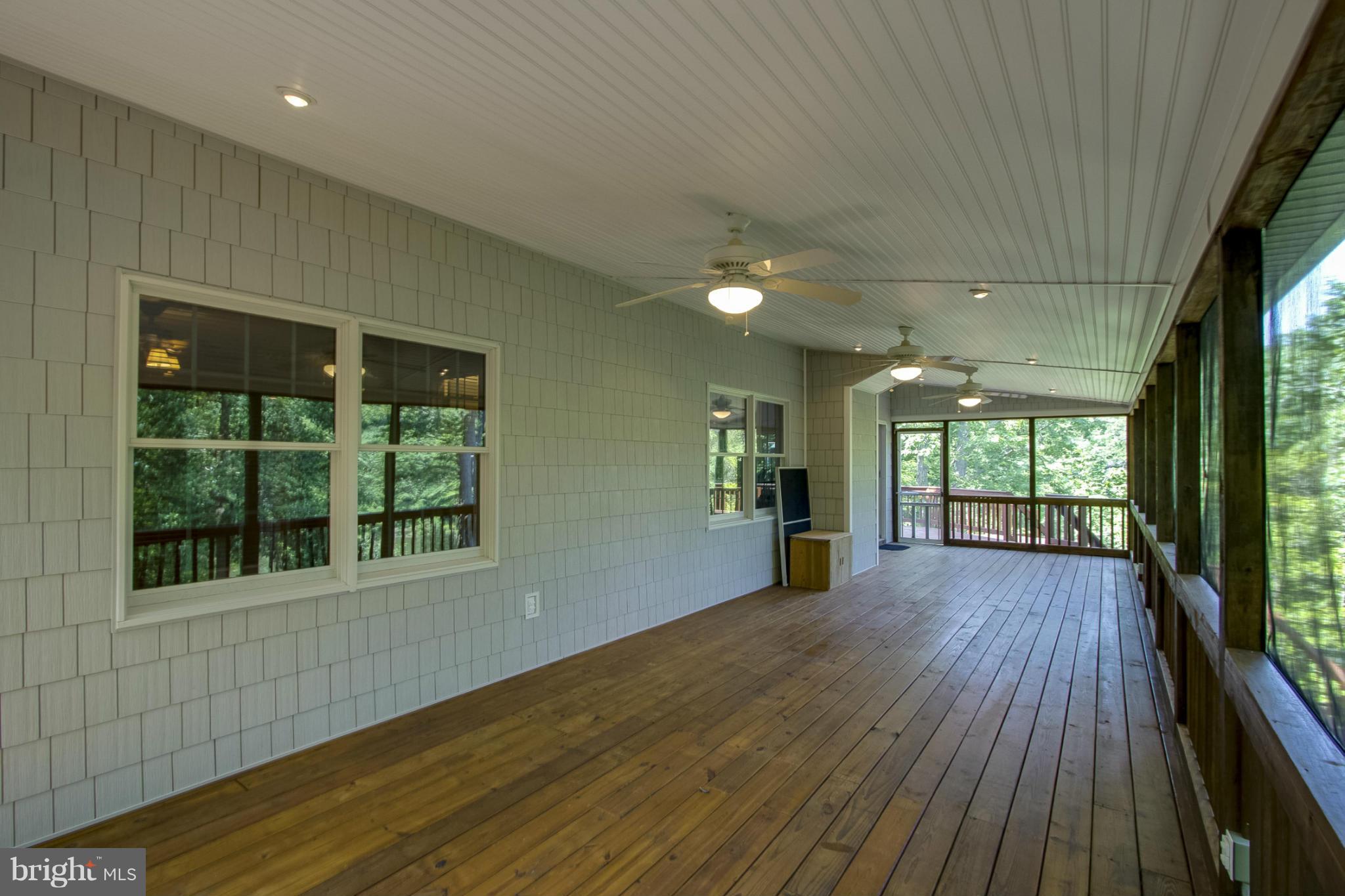 610 Running Fox Road Lusby, MD 20657 - Photo 22 of 30 an empty room with wooden floor and windows