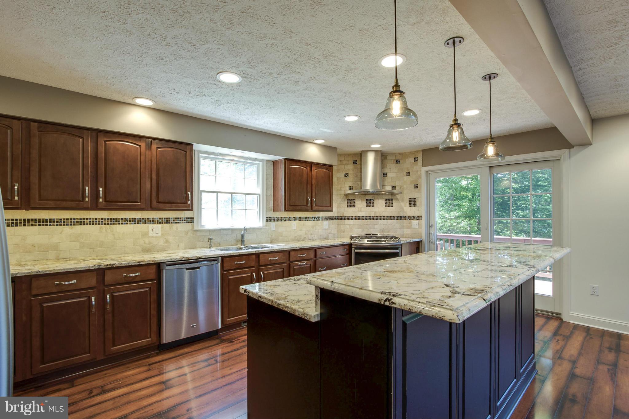 610 Running Fox Road Lusby, MD 20657 - Photo 8 of 30 a kitchen with lots of counter space sink and cabinets