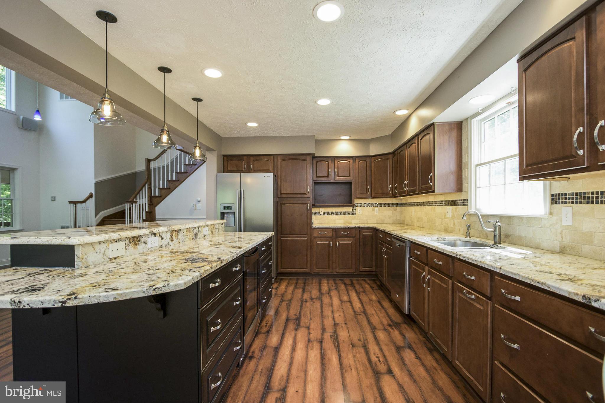 610 Running Fox Road Lusby, MD 20657 - Photo 9 of 30 a kitchen with a sink stove and cabinets