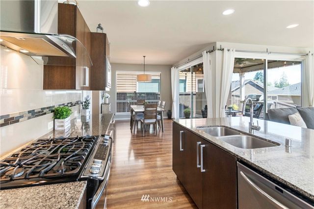 a kitchen with sink stove and cabinets