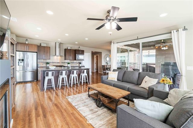 a living room with furniture and kitchen view