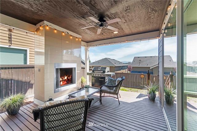 a building outdoor space with patio furniture and a fireplace