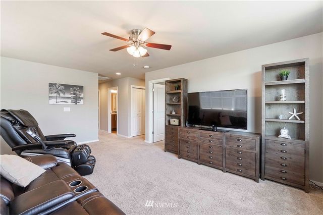 a living room with furniture and flat screen tv