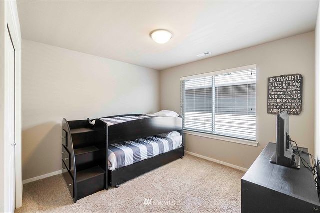 a bedroom with a bed and a desk