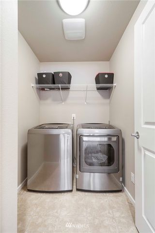 a utility room with two washing machine and a sink