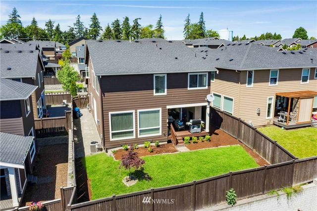 an aerial view of a house with garden space and a car park