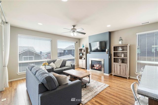 a living room with fireplace furniture and a flat screen tv
