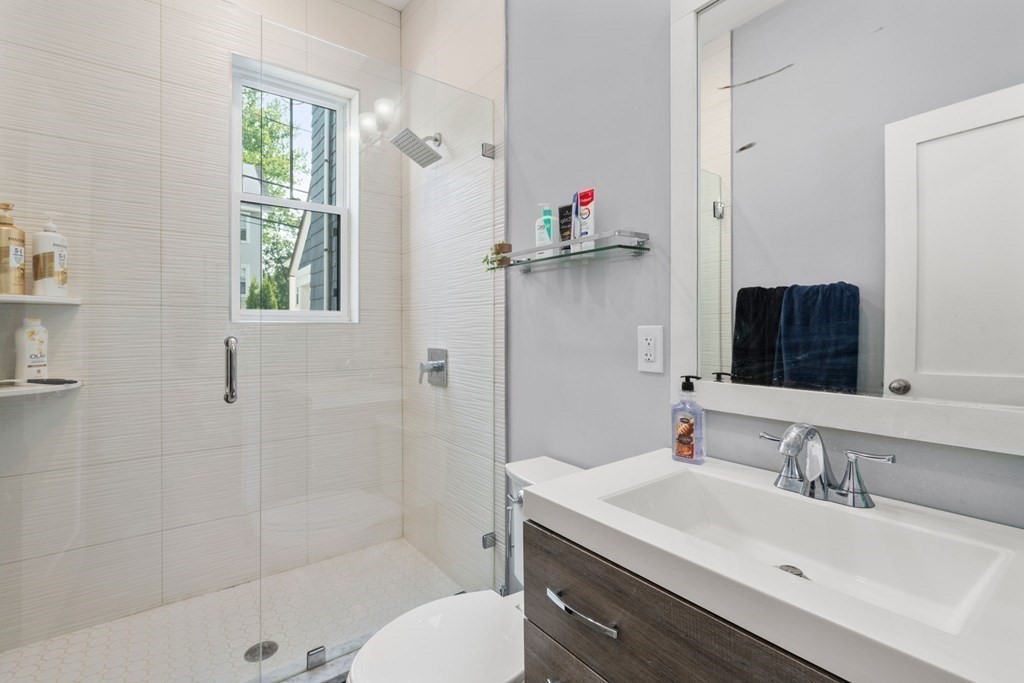 59 Mozart Street, Unit 1 Boston, MA 02130 - Photo 11 of 22 a bathroom with a sink toilet and shower