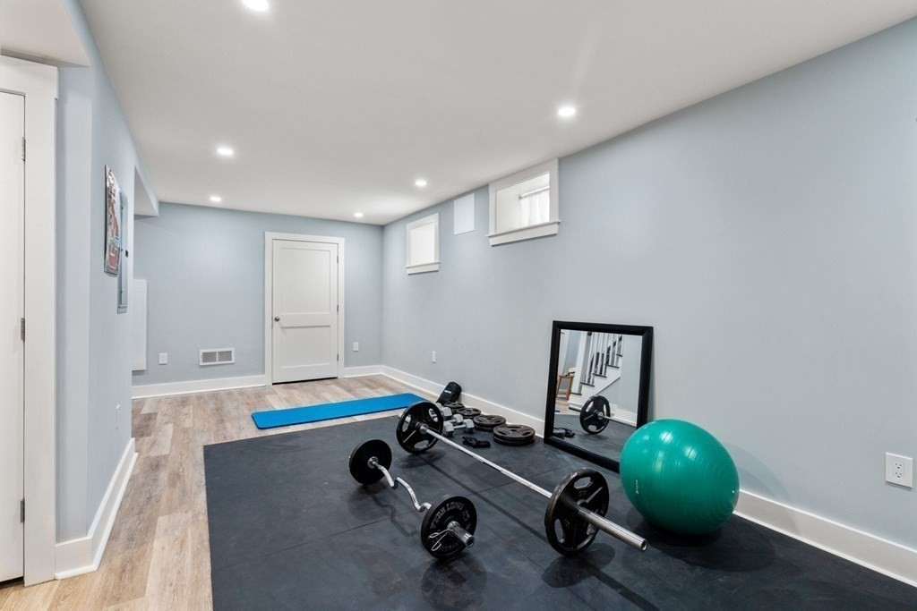 59 Mozart Street, Unit 1 Boston, MA 02130 - Photo 13 of 22 a room with a chair and gym equipment
