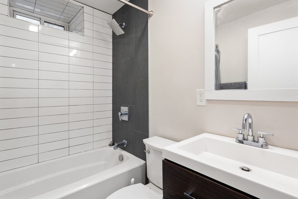 59 Mozart Street, Unit 1 Boston, MA 02130 - Photo 14 of 22 a bathroom with a sink and a bathtub
