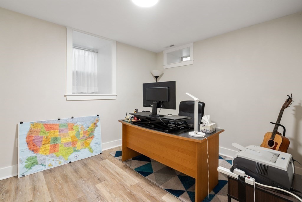 59 Mozart Street, Unit 1 Boston, MA 02130 - Photo 15 of 22 a living room with furniture and a flat screen tv