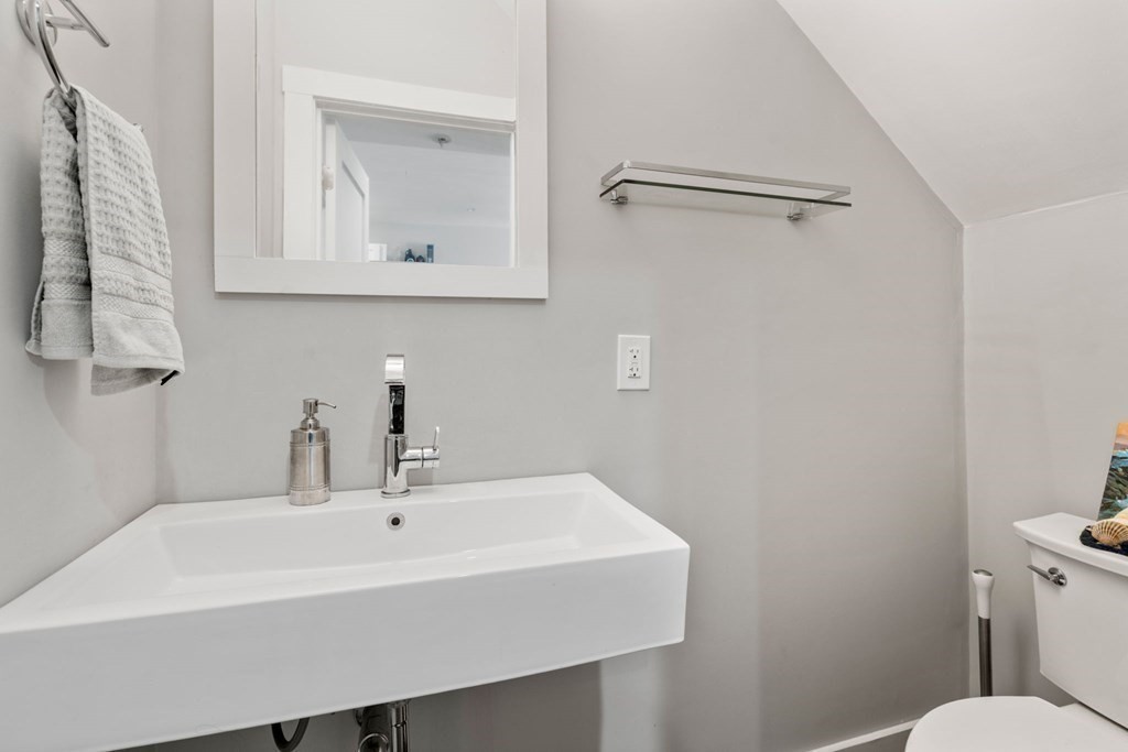 59 Mozart Street, Unit 1 Boston, MA 02130 - Photo 17 of 22 a bathroom with a sink a toilet and a mirror