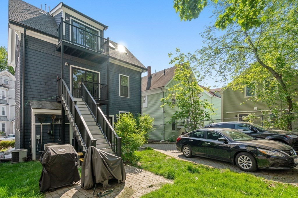 59 Mozart Street, Unit 1 Boston, MA 02130 - Photo 19 of 22 a car parked in front of a brick house