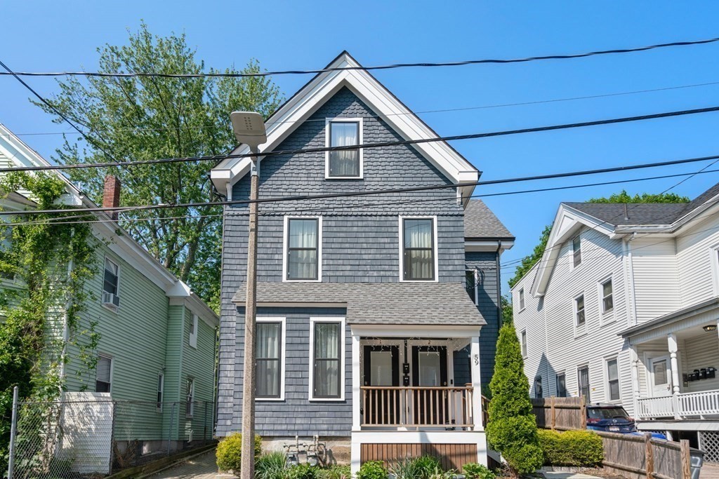 59 Mozart Street, Unit 1 Boston, MA 02130 - Photo 21 of 22 a view of a house with a small yard and plants