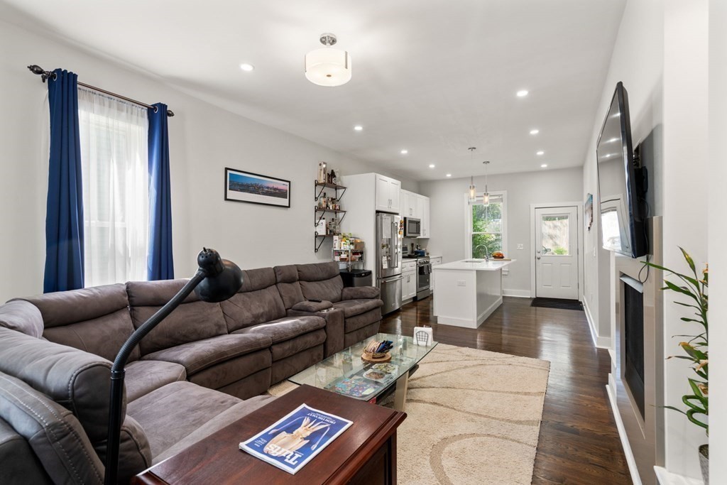 59 Mozart Street, Unit 1 Boston, MA 02130 - Photo 3 of 22 a living room with furniture and a wooden floor