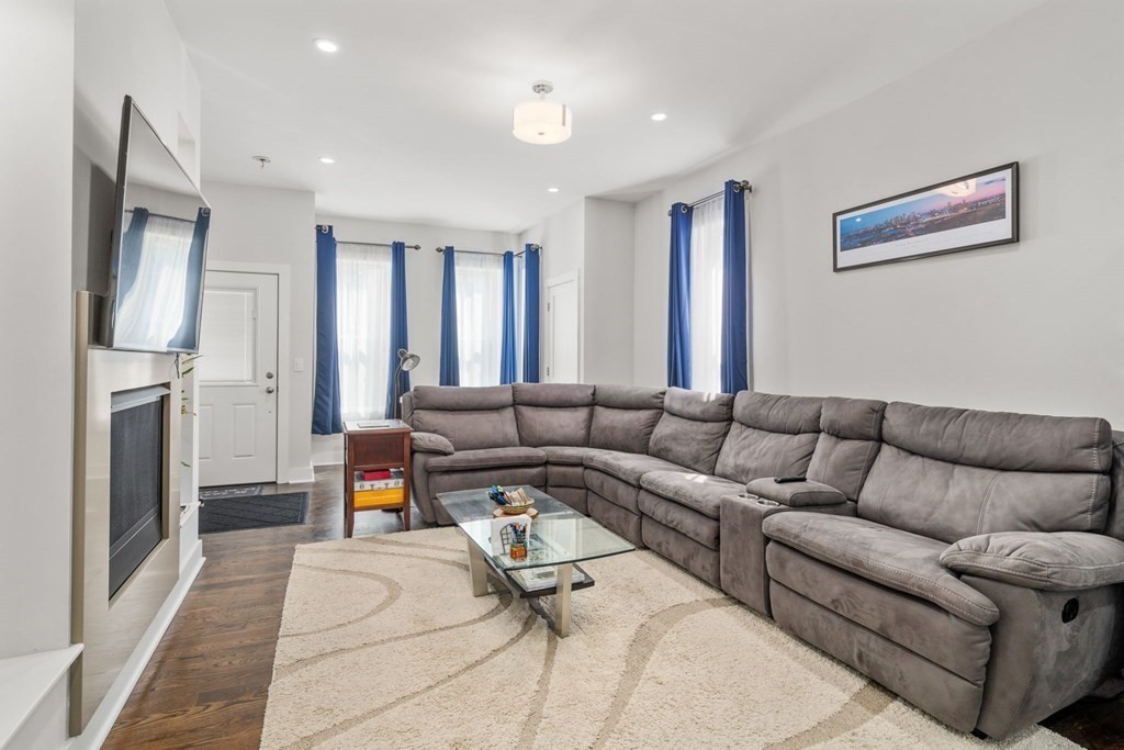 59 Mozart Street, Unit 1 Boston, MA 02130 - Photo 5 of 22 a living room with furniture and a fireplace