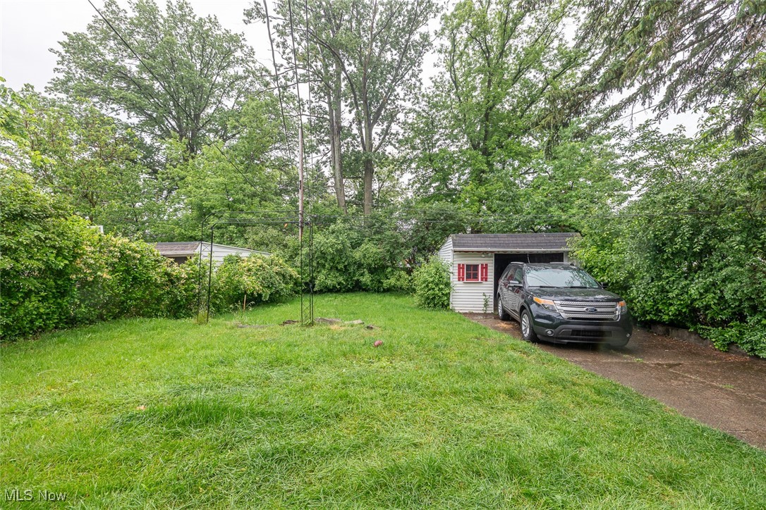 21202 Franklin Road Maple Heights, OH 44137 - Photo 25 of 28 View of green lawn with driveway and an outbuilding