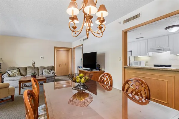 a living room with furniture a flat screen tv and a large window