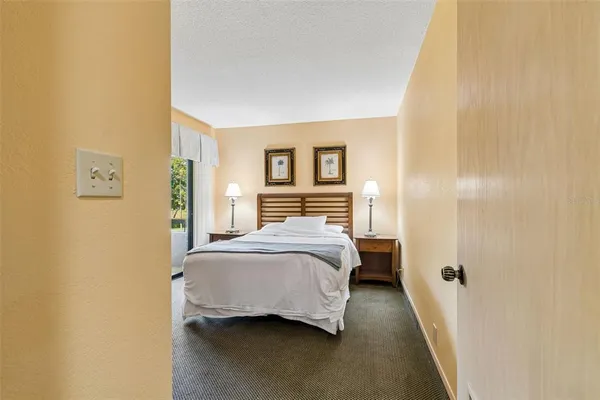 a bathroom with a granite countertop sink mirror vanity and toilet