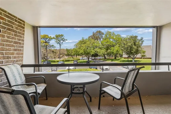 a view of a chairs and table in patio