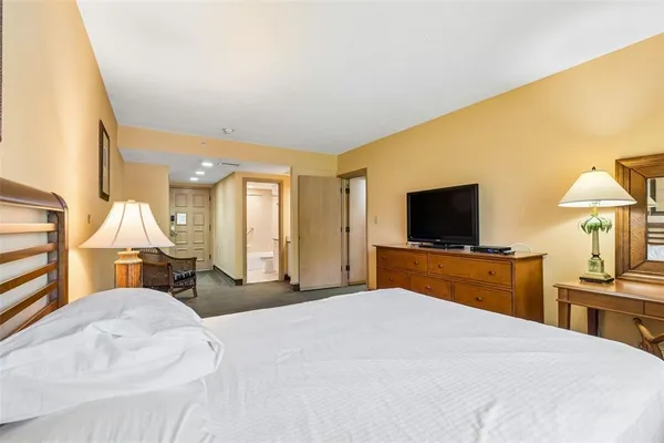 an aerial view of a house a yard and mountain view in back