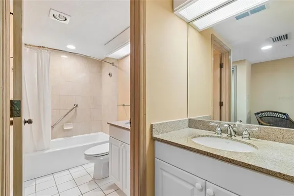 a view of a street with a building and palm tree