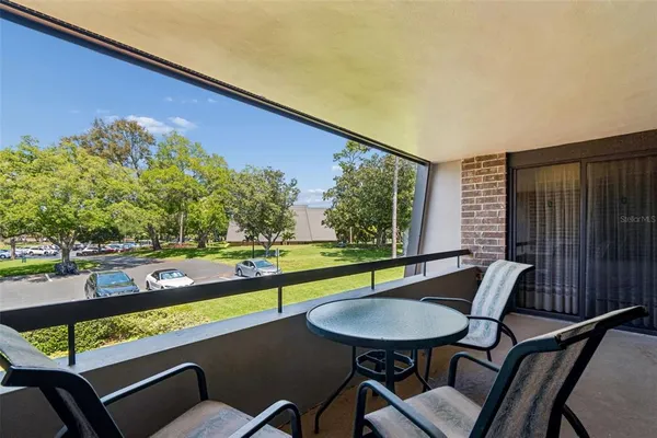 a view of a chairs and table in patio
