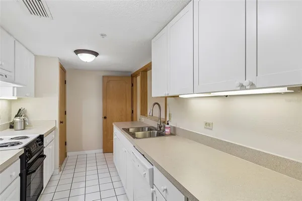 a living room with furniture kitchen view and a flat screen tv