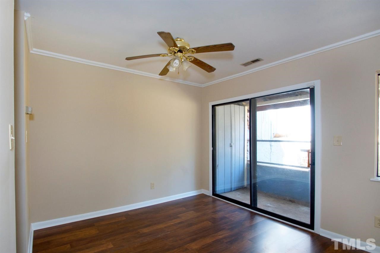 5924 Farm Gate Road Raleigh, NC 27606 - Photo 12 of 17 an empty room with wooden floor door and windows