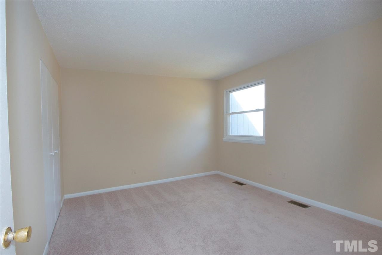5924 Farm Gate Road Raleigh, NC 27606 - Photo 13 of 17 an empty room with a window