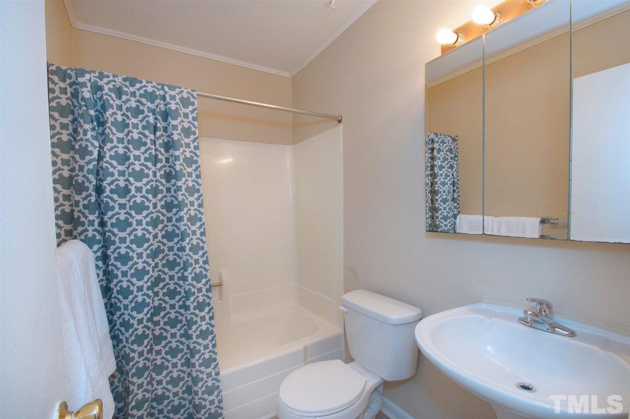 5924 Farm Gate Road Raleigh, NC 27606 - Photo 14 of 17 a bathroom with a sink toilet and shower