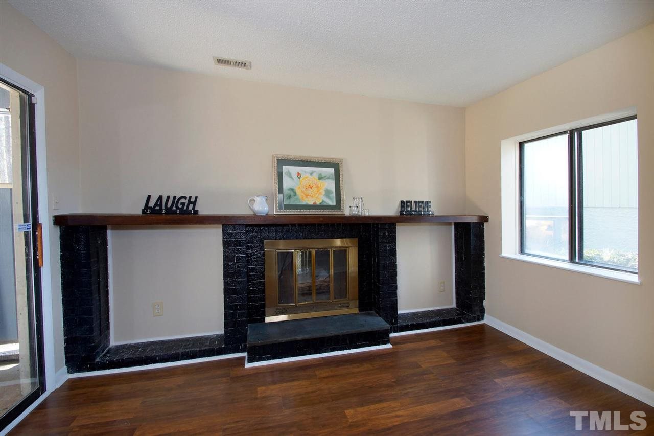 5924 Farm Gate Road Raleigh, NC 27606 - Photo 3 of 17 a view of an empty room with wooden floor and a window