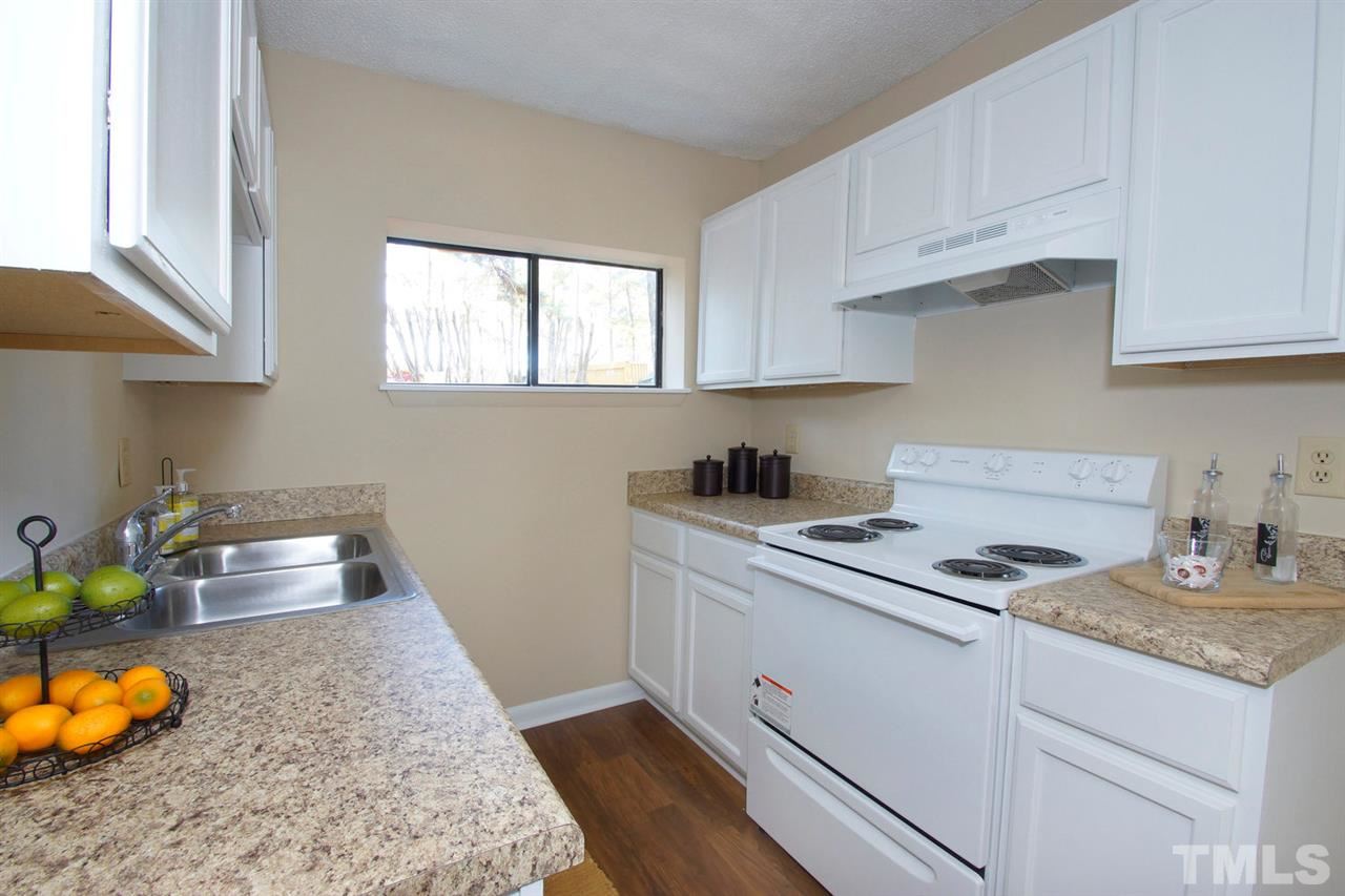 5924 Farm Gate Road Raleigh, NC 27606 - Photo 5 of 17 a kitchen with stainless steel appliances granite countertop a sink stove and cabinets