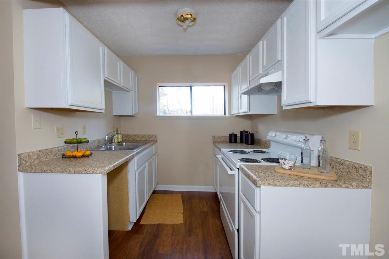 5924 Farm Gate Road Raleigh, NC 27606 - Photo 6 of 17 a kitchen with stainless steel appliances granite countertop a sink stove and refrigerator