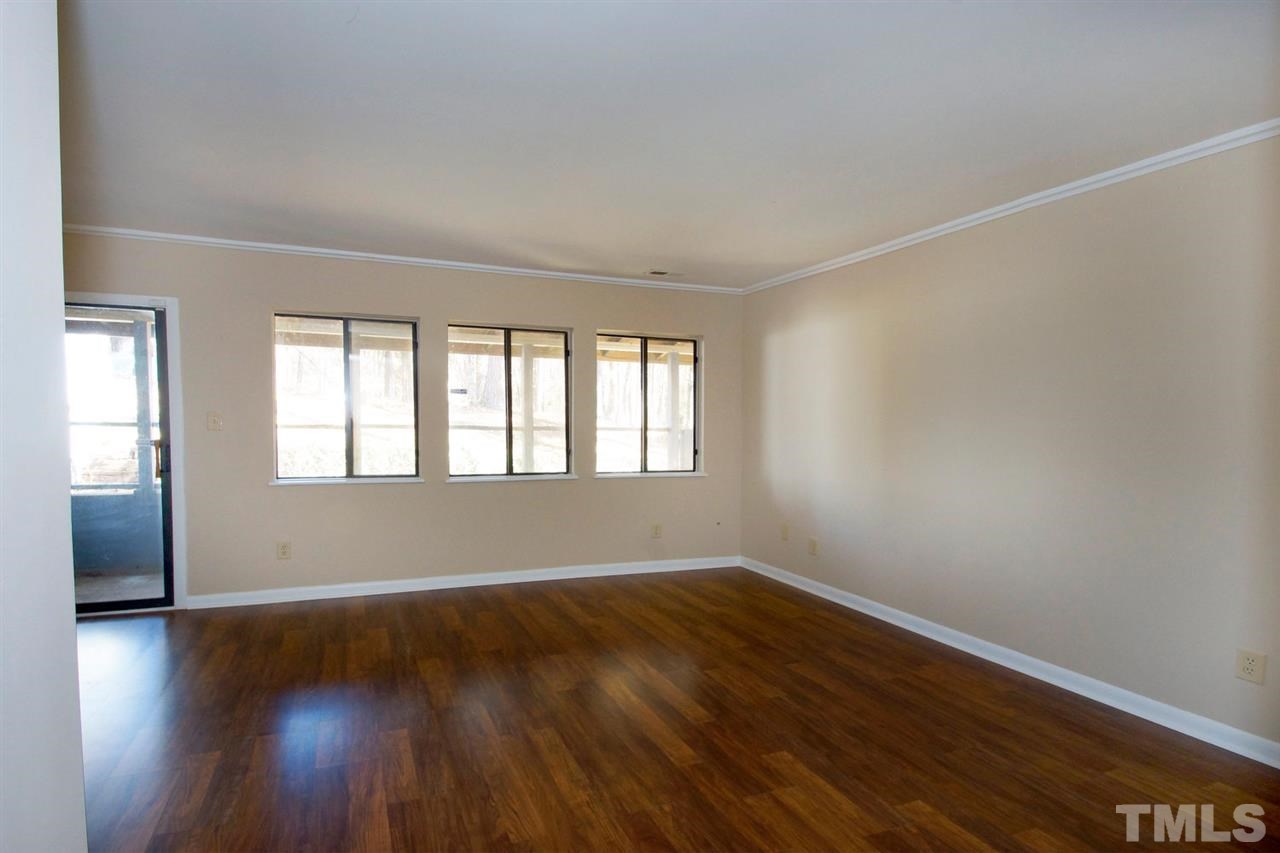 5924 Farm Gate Road Raleigh, NC 27606 - Photo 9 of 17 wooden floor in an empty room with a window