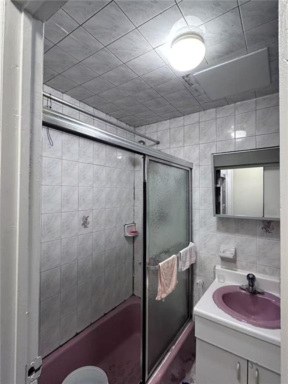 458 58th Street Brooklyn, NY 11220 - Photo 8 of 11 a bathroom with a sink and a mirror