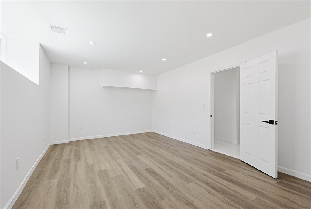 175 Pleasant Street Upton, MA 01568 - Photo 32 of 39 wooden floor in an empty room with a window