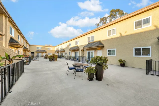 a view of a patio with table and chairs and potted plants